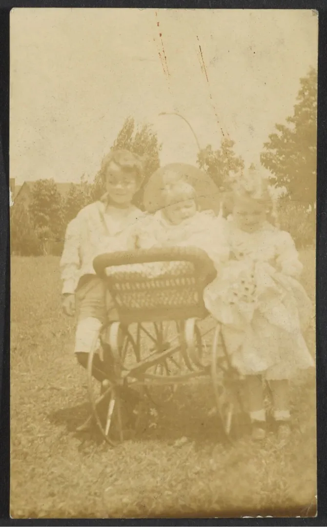 Three of the Roosevelt children photographed outdoors on a windy day
