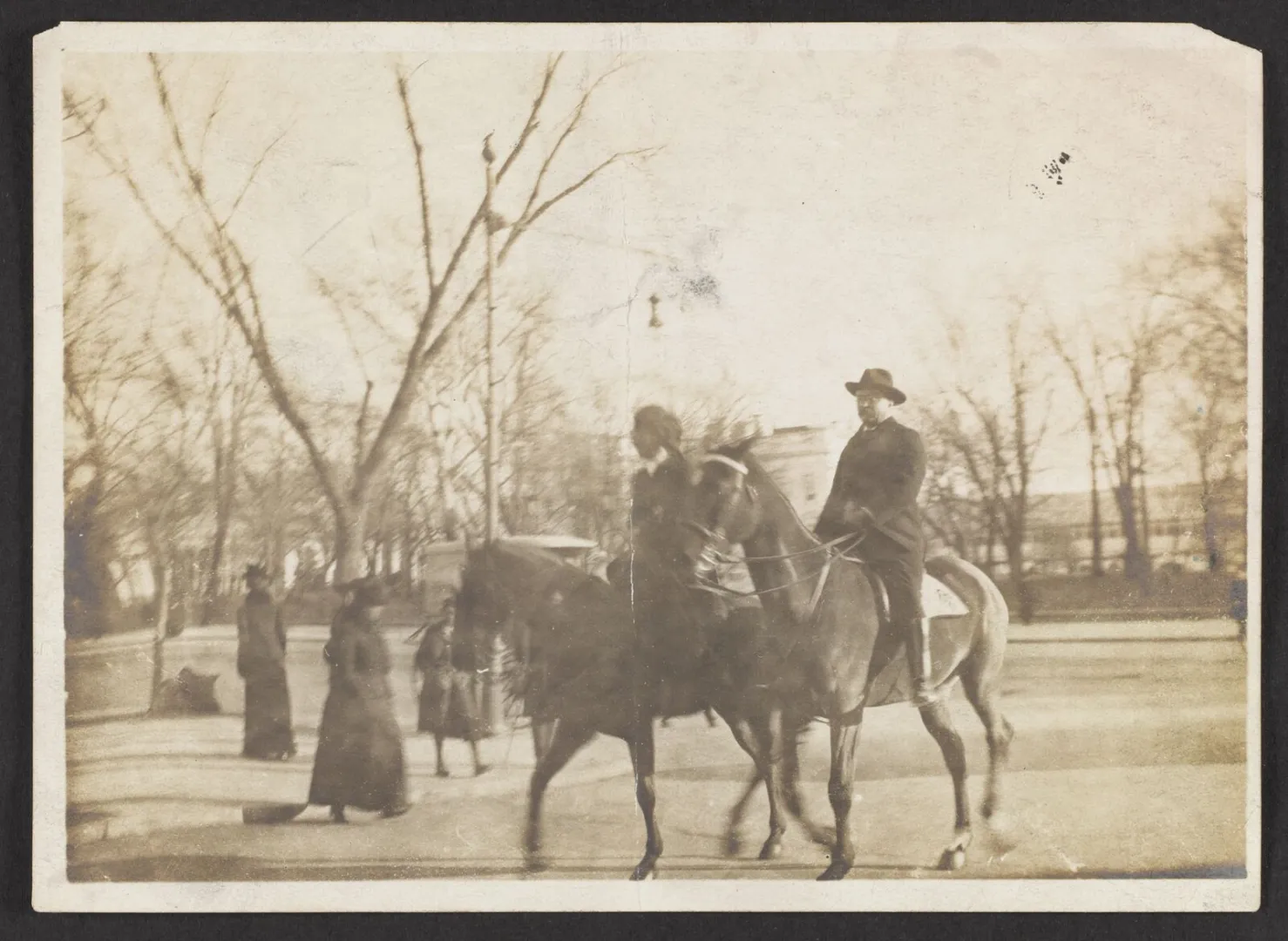 Theodore Roosevelt and Edith Roosevelt riding horses together outdoors