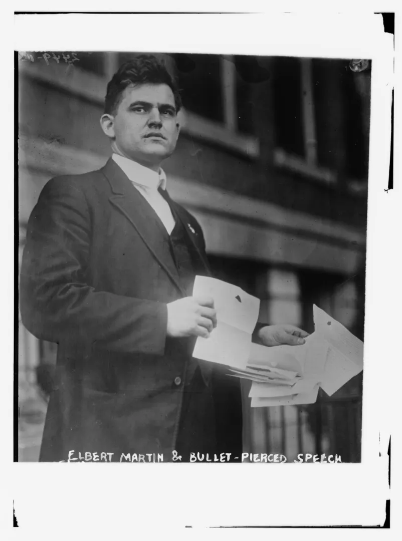 Roosevelt aide Elbert Martin holding the folded, bullet-pierced manuscript of the Milwaukee speech, 1912