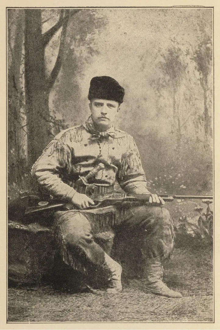 Theodore Roosevelt in fringed buckskin with his rifle