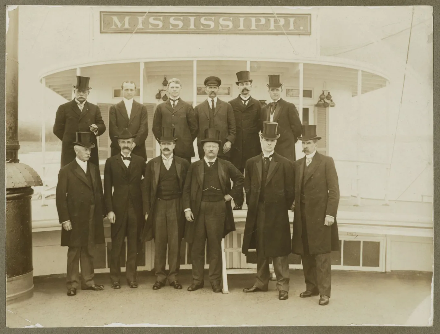 Members of the Inland Waterways Commission in top hats and coats before the steamboat Mississippi
