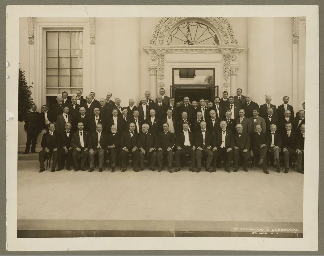 Large group of delegates seated and standing on the White House steps at the 1908 Conference of Governors