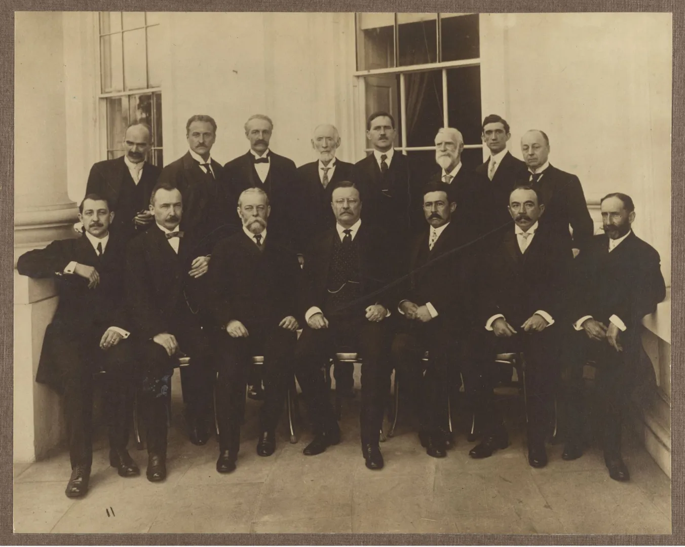 Formal seated group portrait of conservation conference delegates with Theodore Roosevelt at center