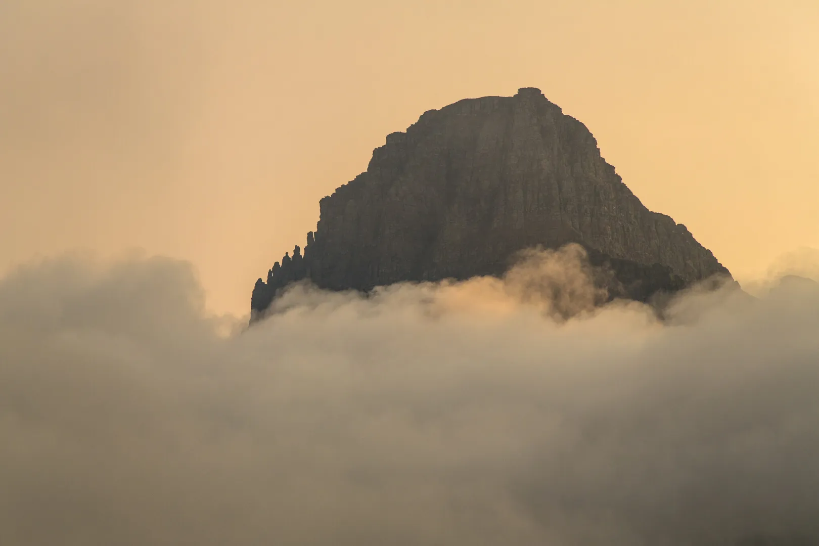 Clements Mountain rising above a layer of cloud at Logan Pass in Glacier National Park, Montana