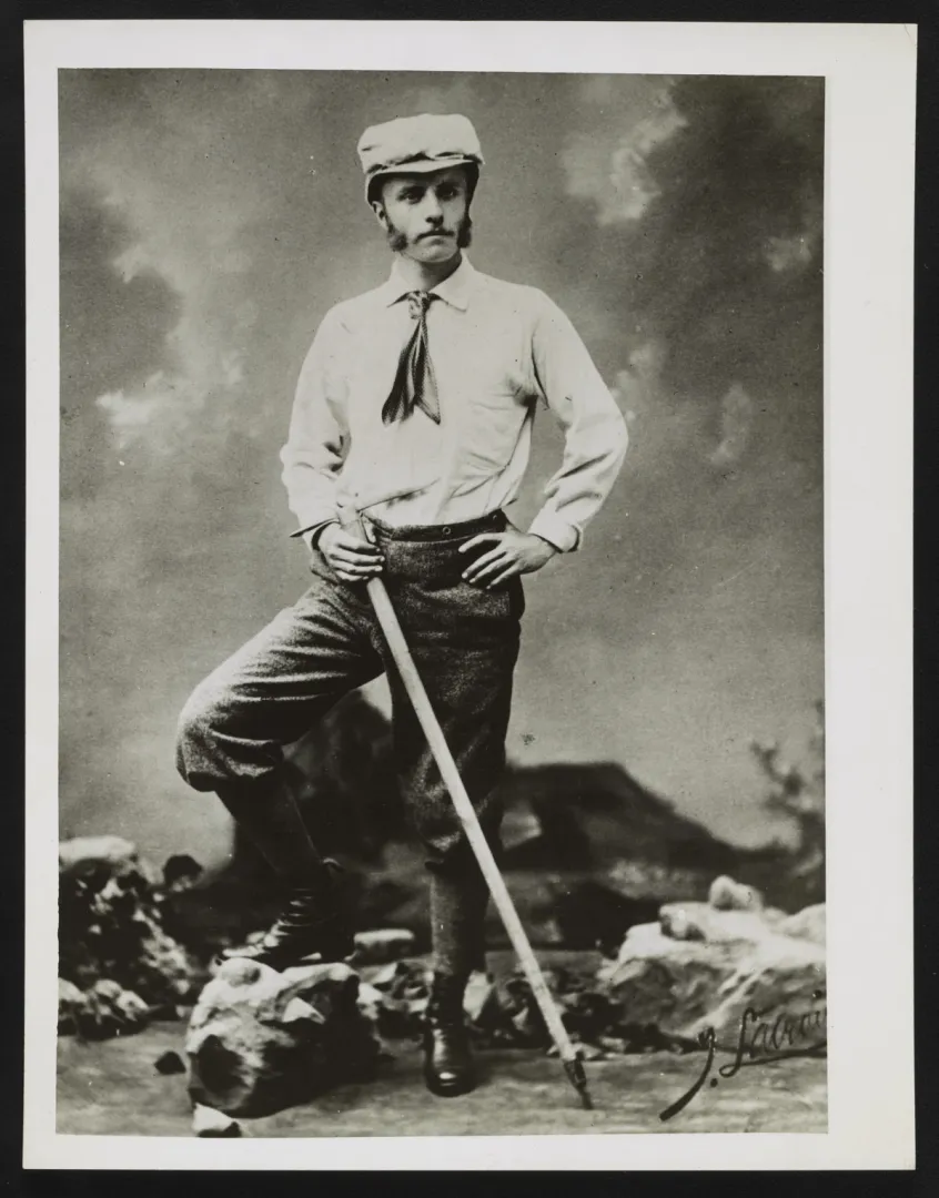 Young Theodore Roosevelt dressed for mountain climbing, holding an alpenstock