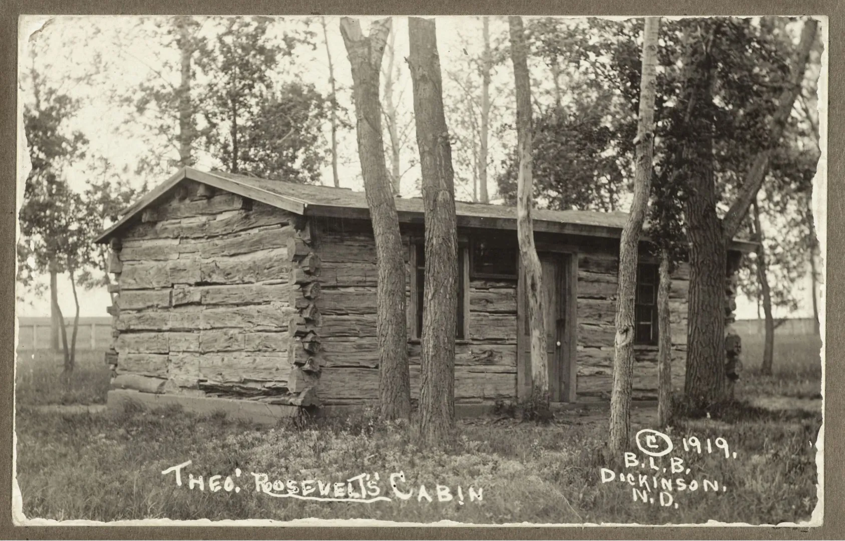 Theodore Roosevelt's log cabin at the Maltese Cross Ranch, set among cottonwoods