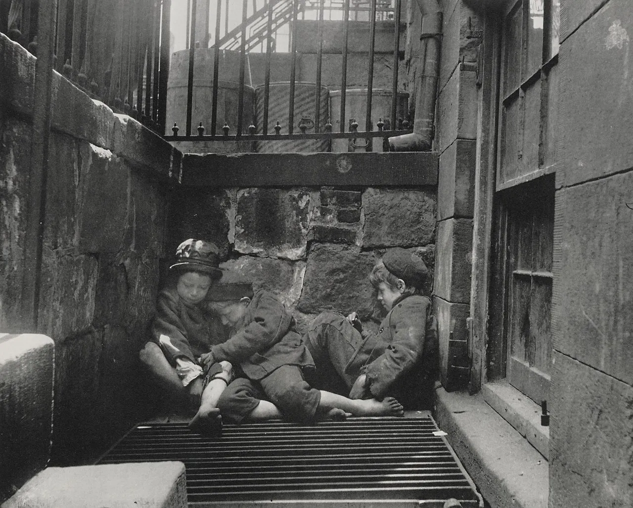 Riis photograph of homeless boys sleeping over a street grating