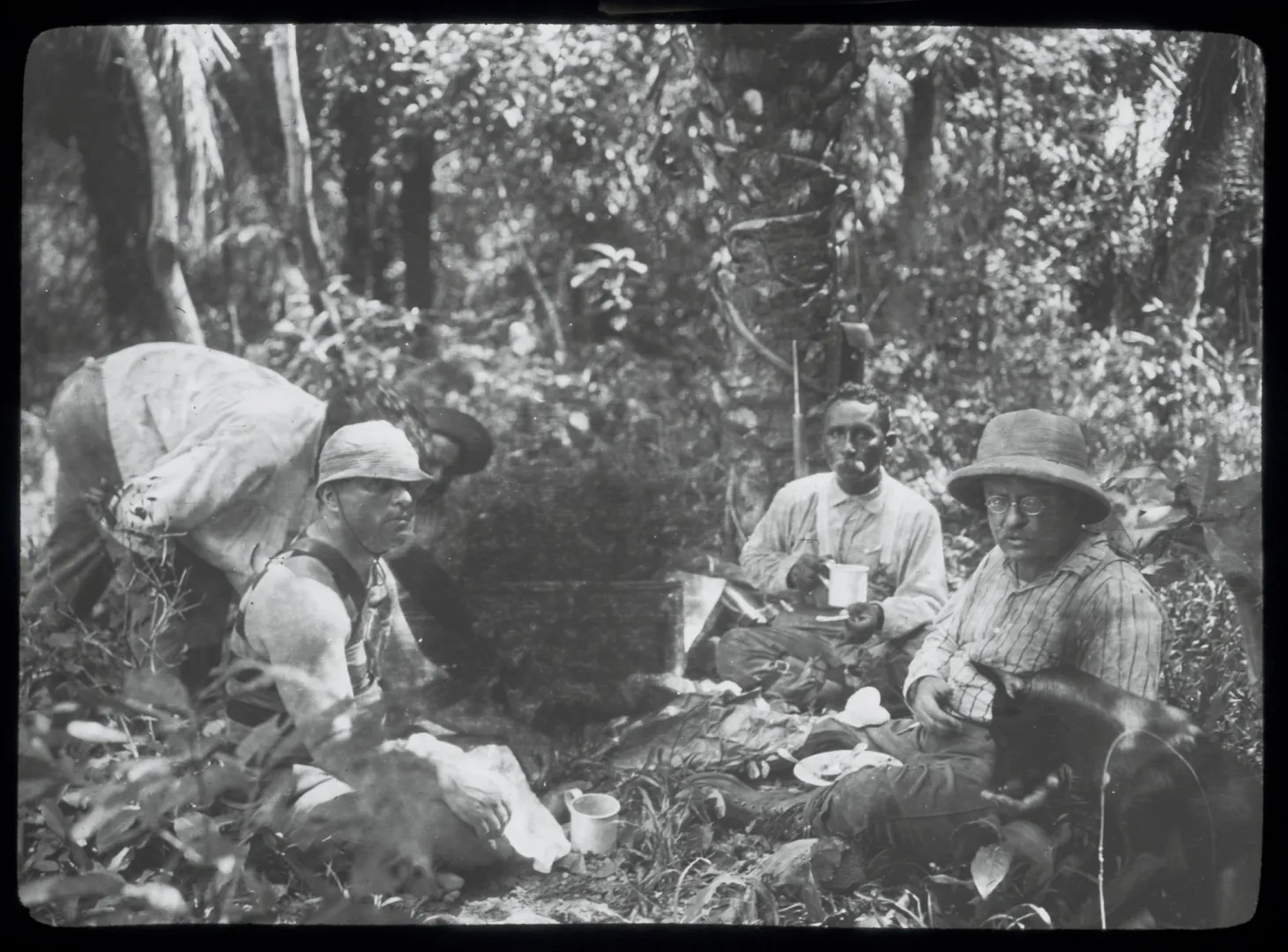 Expedition members resting in a jungle camp