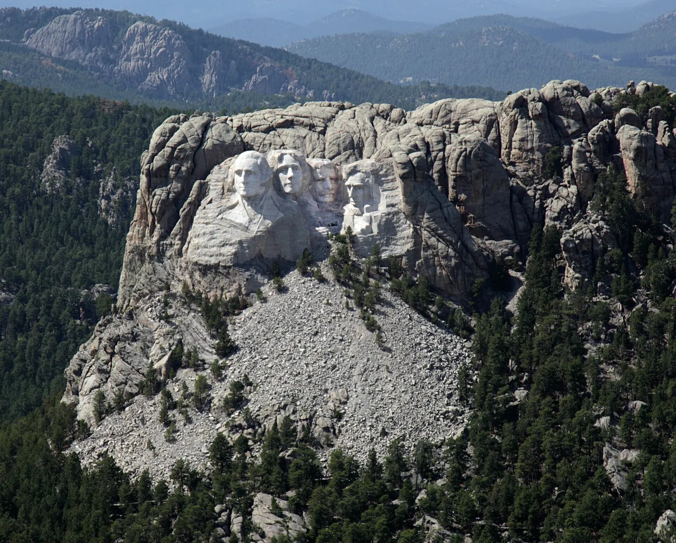 Aerial view of the Mount Rushmore carving in the granite of the Black Hills, surrounded by ponderosa pine