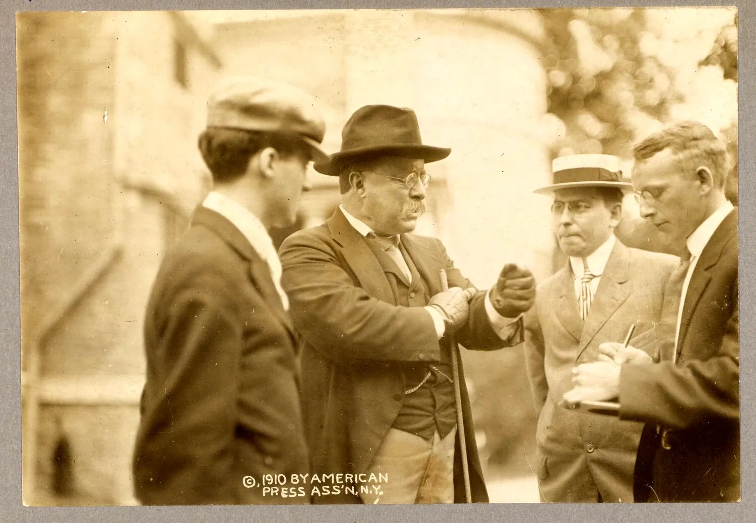 Theodore Roosevelt in conversation with several reporters