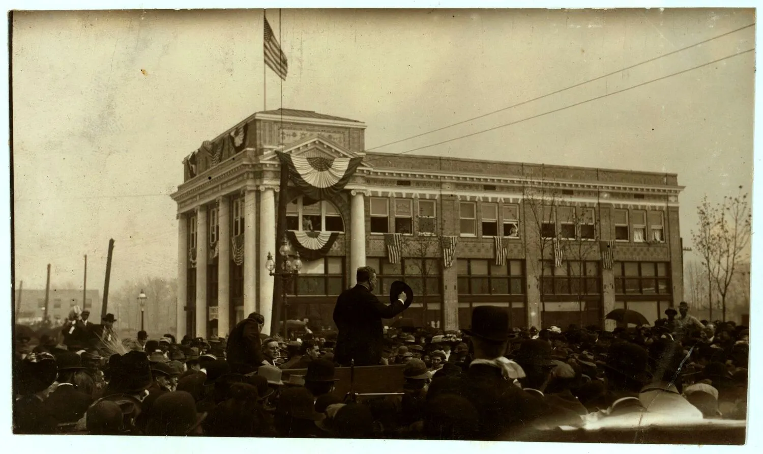 Theodore Roosevelt addressing a large outdoor crowd