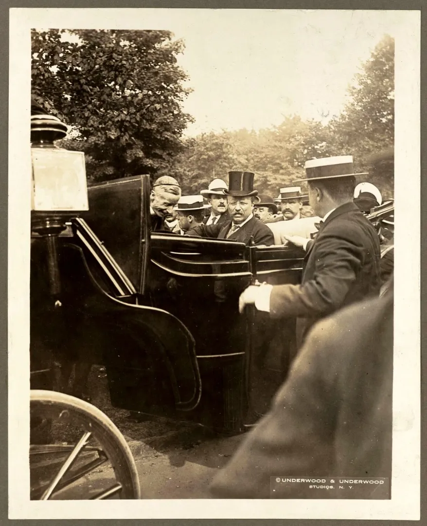 President Roosevelt greeting crowds from a carriage