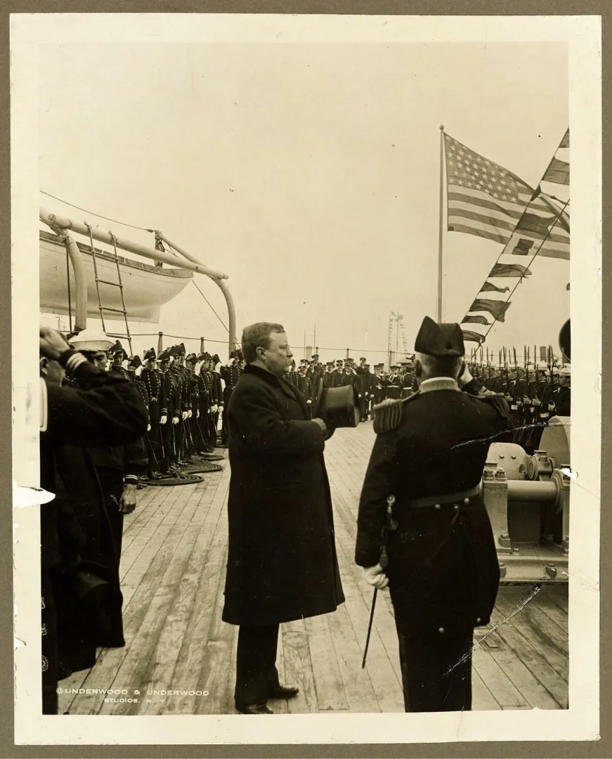 President Roosevelt reviewing sailors aboard a battleship