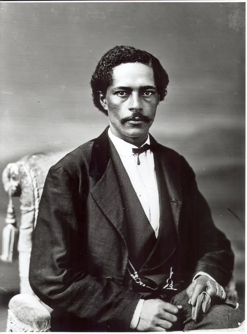 Studio portrait of John R. Lynch, seated