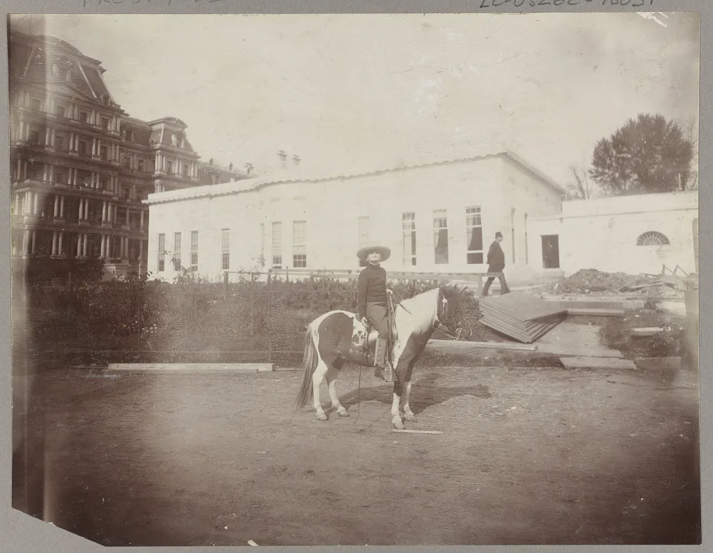 Archie Roosevelt seated on his pony Algonquin outside the White House offices
