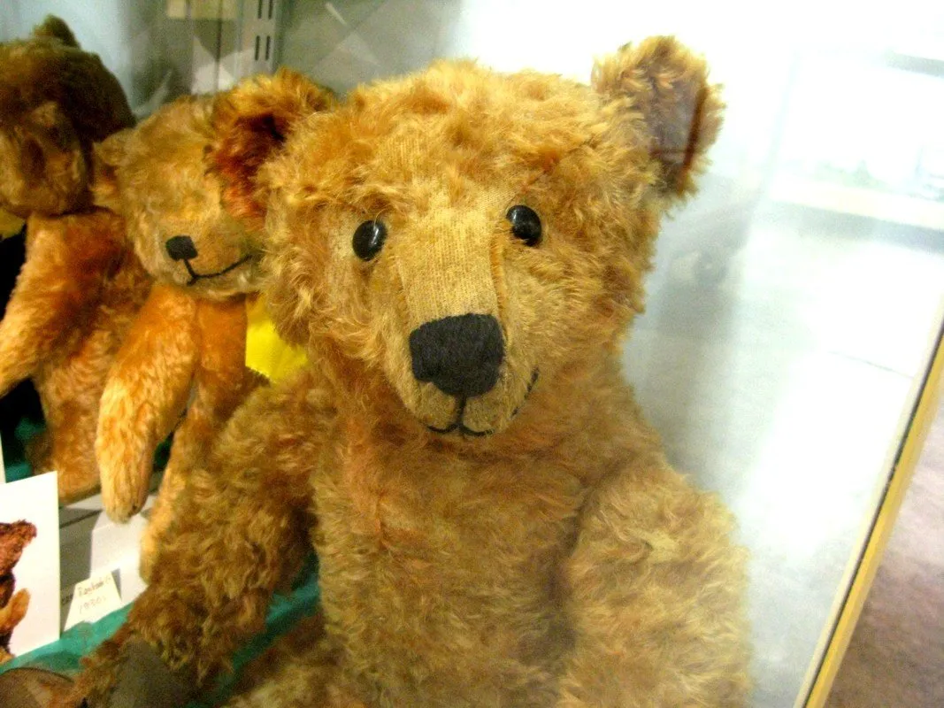 Vintage mohair Steiff teddy bears displayed in a museum case
