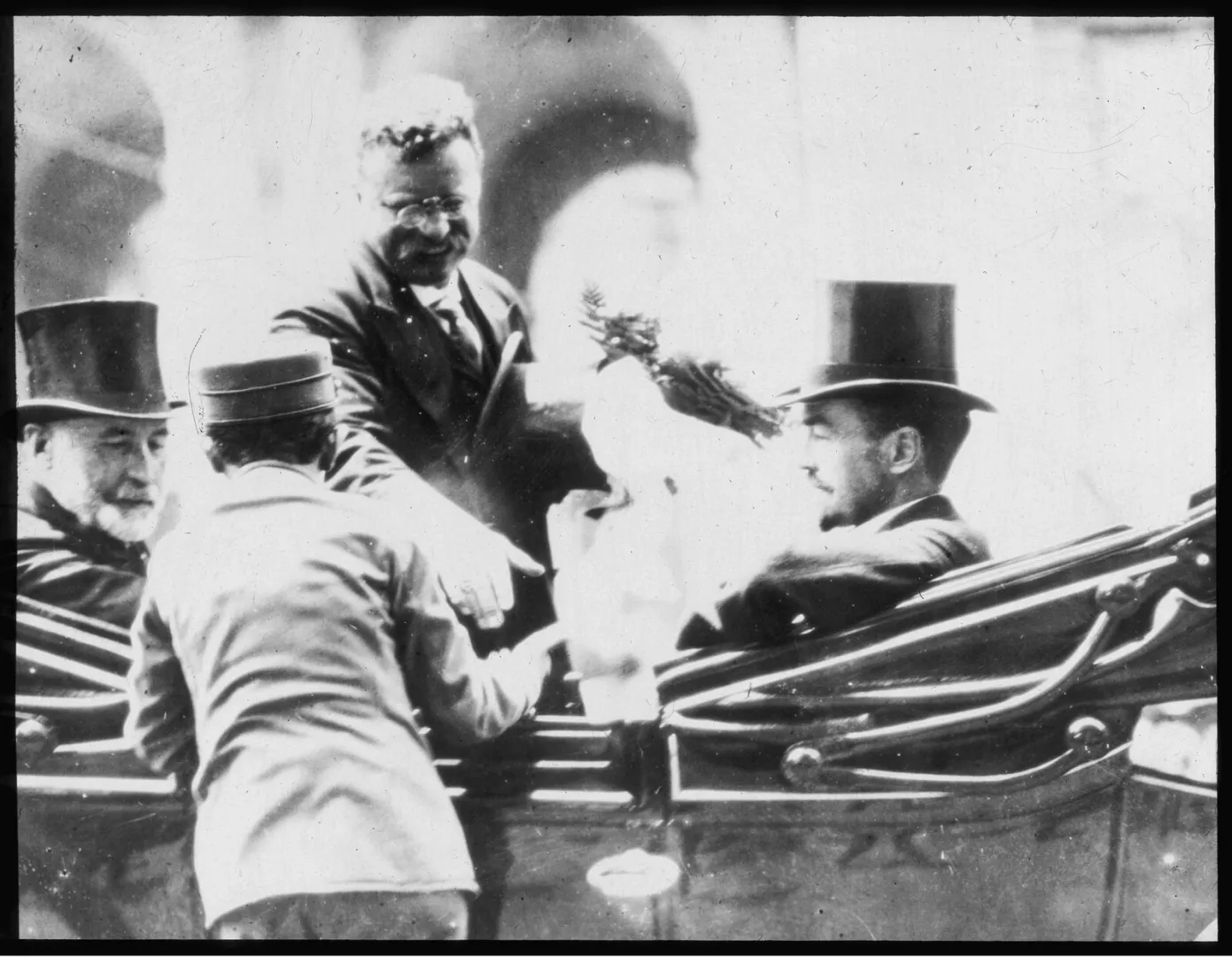 Theodore Roosevelt in an open carriage receiving flowers from well-wishers on his return to New York in 1910