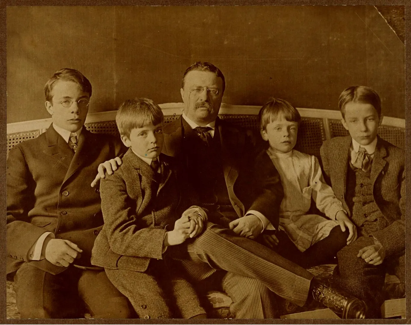 Theodore Roosevelt seated with his four sons