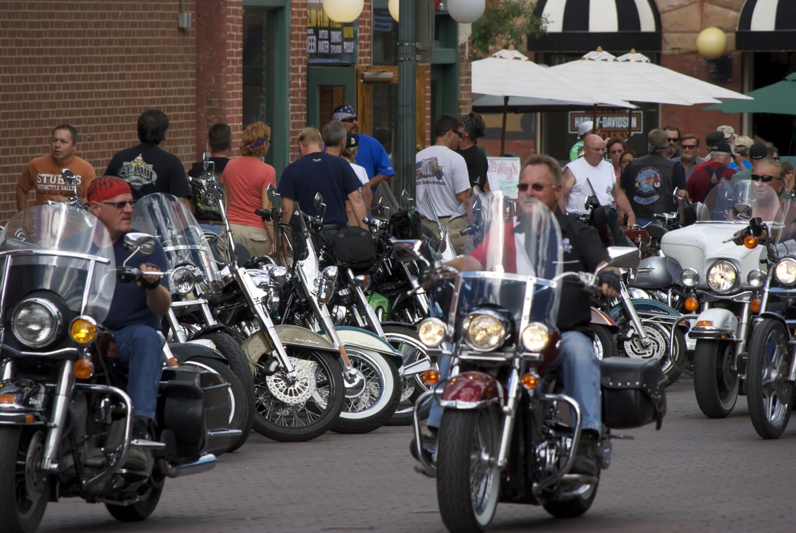 Riders and parked motorcycles crowding Main Street in Sturgis, South Dakota during the rally