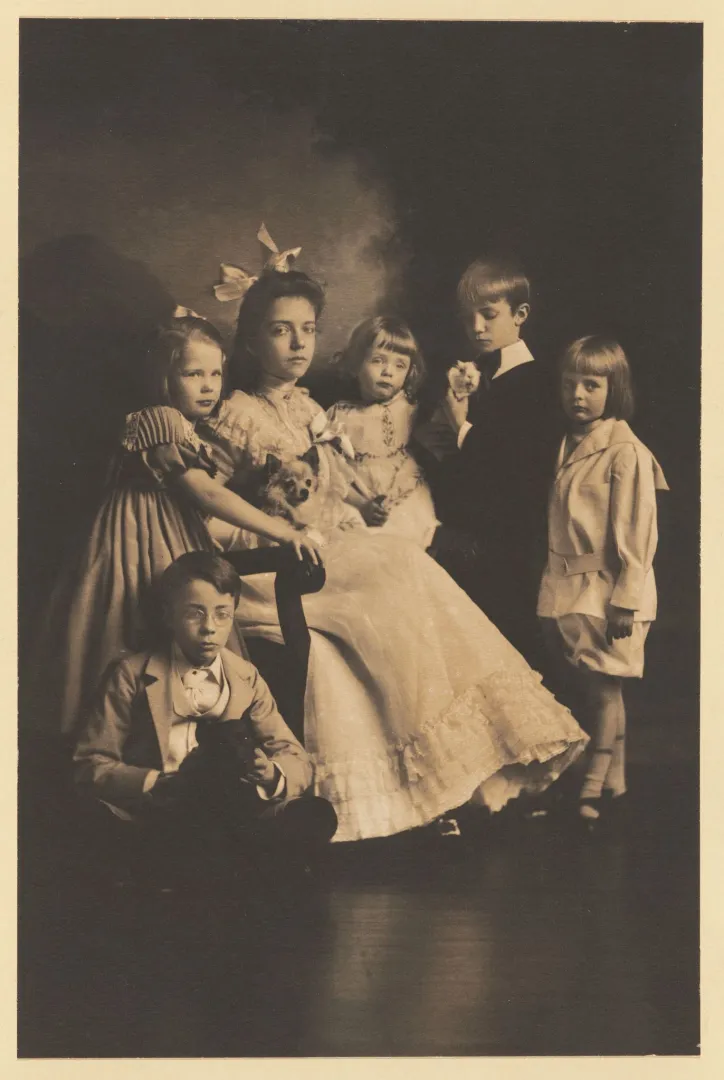 Studio group portrait of the Roosevelt children gathered together, one holding a small pet