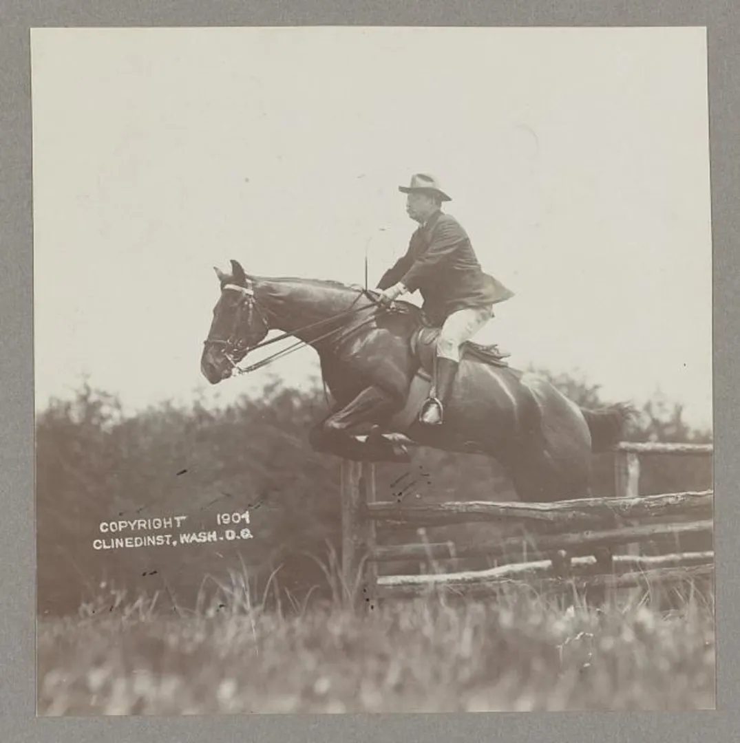 Theodore Roosevelt on horseback, his horse clearing a fence