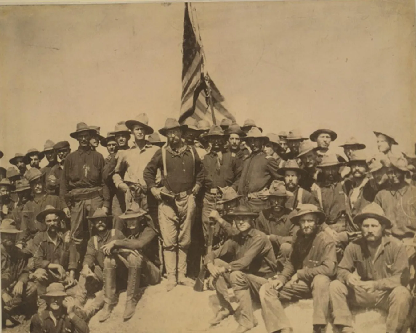 Colonel Theodore Roosevelt and his Rough Riders at the top of the hill they captured near Santiago, Cuba, 1898
