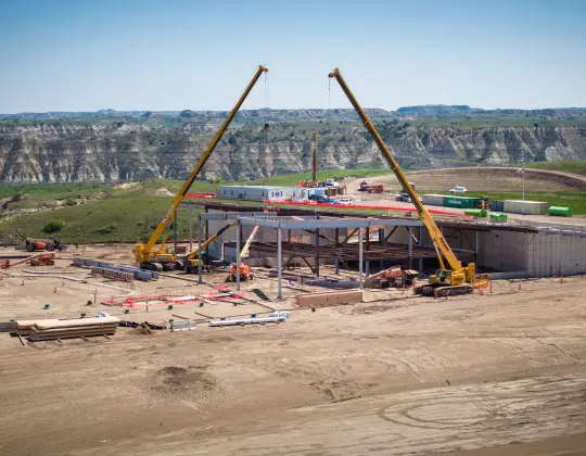 Two cranes setting timbers in place