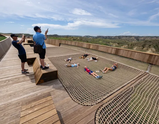 Visitors on the Library rooftop boardwalk overlooking the Badlands landscape