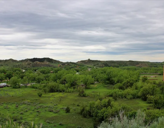 Wide view of the Medora valley under a cloudy sky