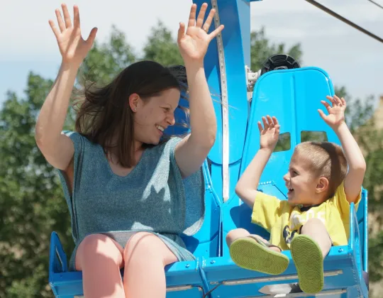 Parent and child riding the two-seat zipline