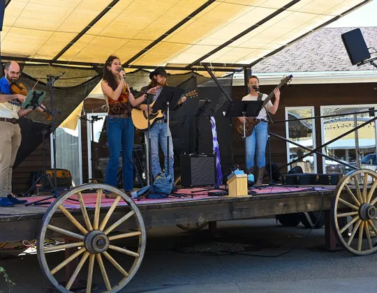Band playing on the wagon stage on the Town Square Patio
