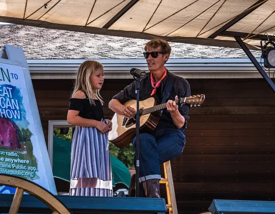 Musicians performing the Great American Folk Show on the patio