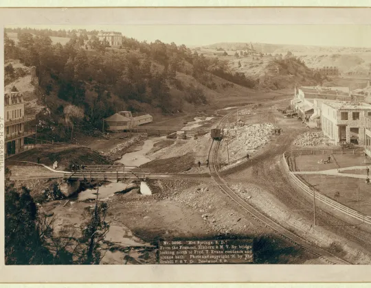 Sepia historic photograph of Hot Springs, South Dakota, seen from a railroad bridge