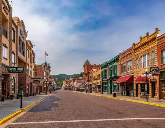 Brick storefronts and the hills above Main Street in Deadwood