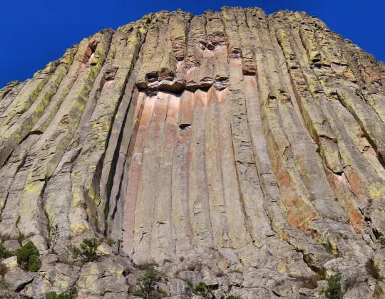 Close view of the columns of Devils Tower with a hollow window in the rock