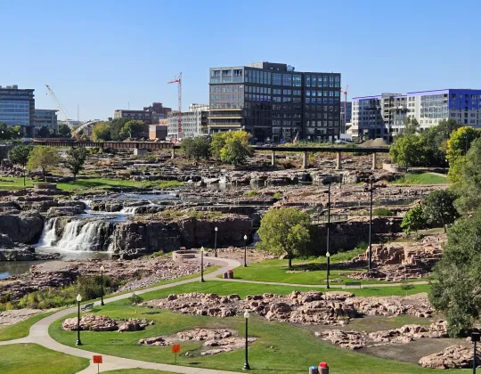 The Big Sioux River falls with downtown Sioux Falls behind