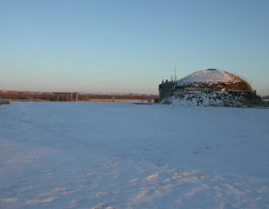 A reconstructed earthlodge on the snowy prairie at Knife River