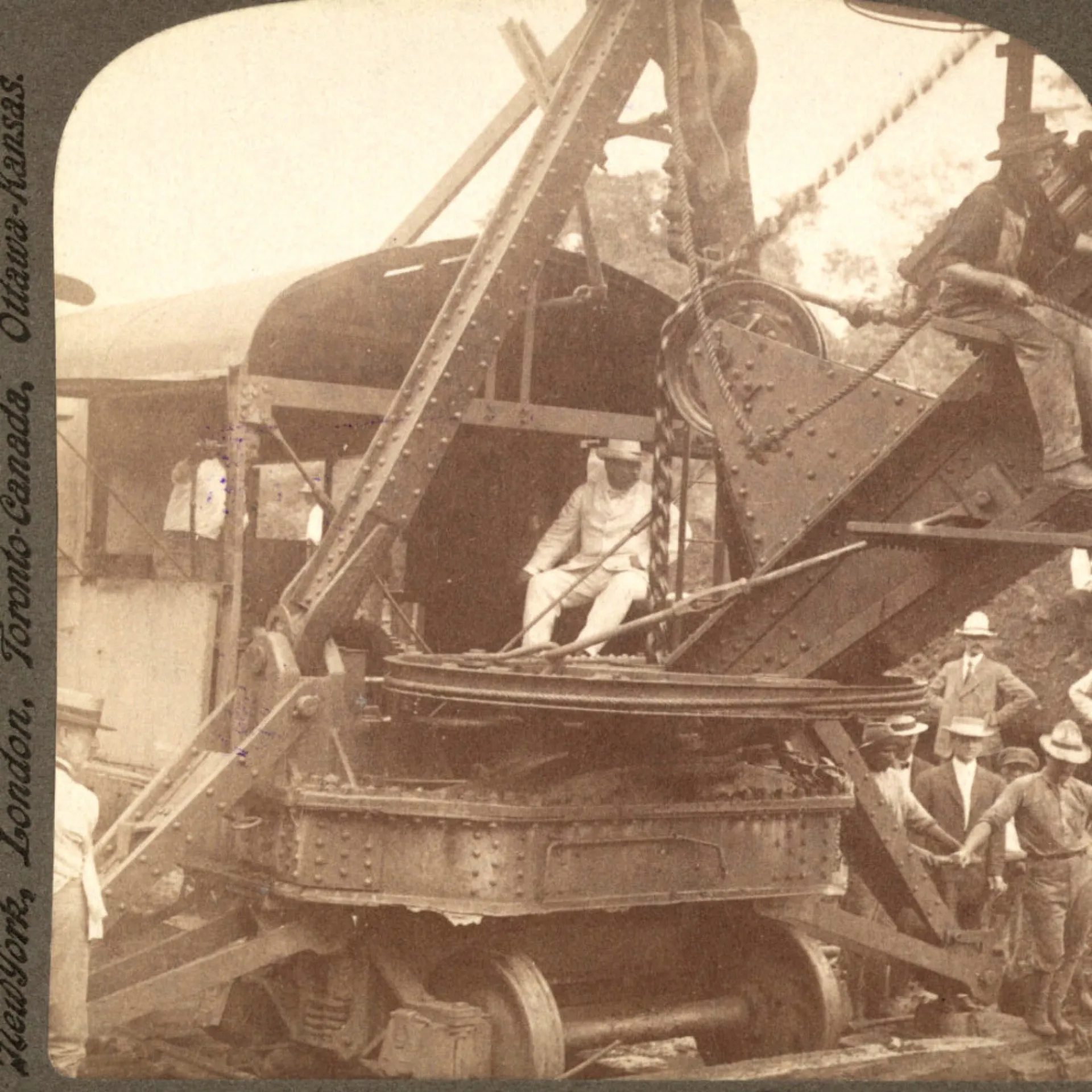 Theodore Roosevelt seated at the controls of a steam shovel at the Panama Canal