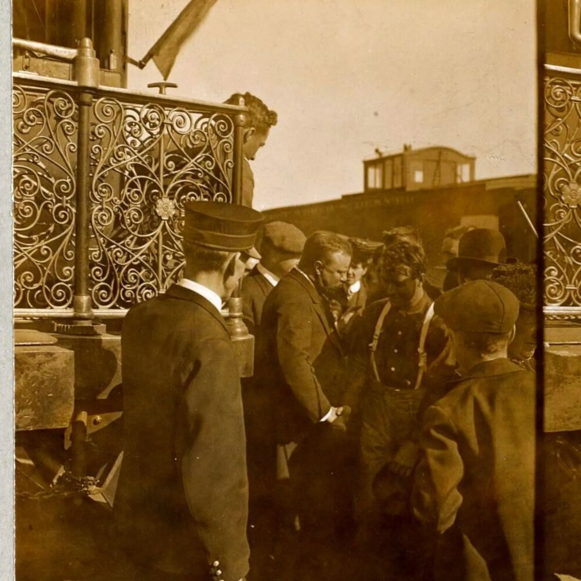 Theodore Roosevelt greeting working men from a platform